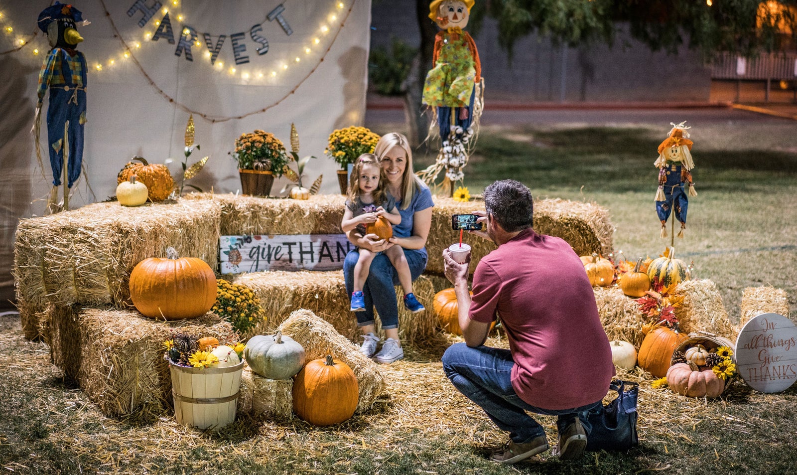 Families and kids at a community center’s Boo-fest trunk-or-treat event.