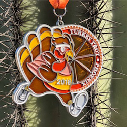 Participants gather at the starting line of a 2025 Phoenix Turkey Trot, celebrating Thanksgiving fitness and community spirit.